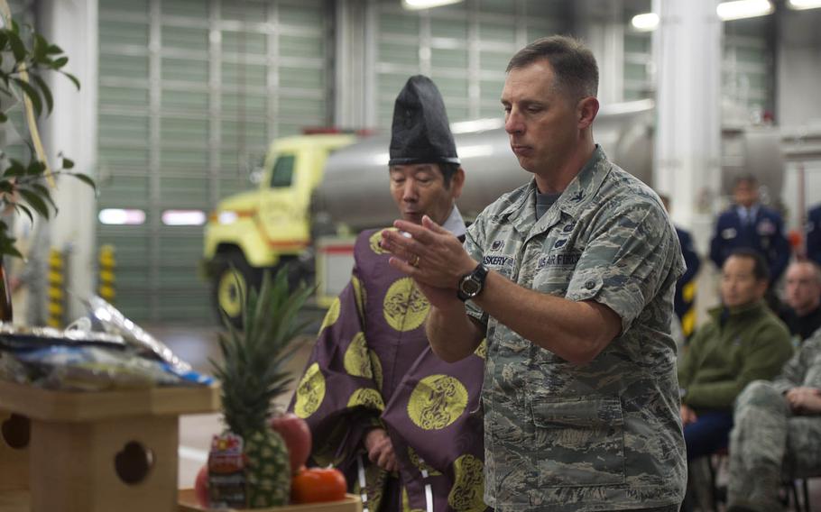 Col. Scott Maskery, 374th Mission Support Group commander, offers prayers during a blessing-of-the-fleet ceremony at Yokota Air Base, Japan, Nov. 25, 2015. The blessing was followed by a push-in ceremony, during which Yokota firefighters pushed the new engine into the firehouse by hand.