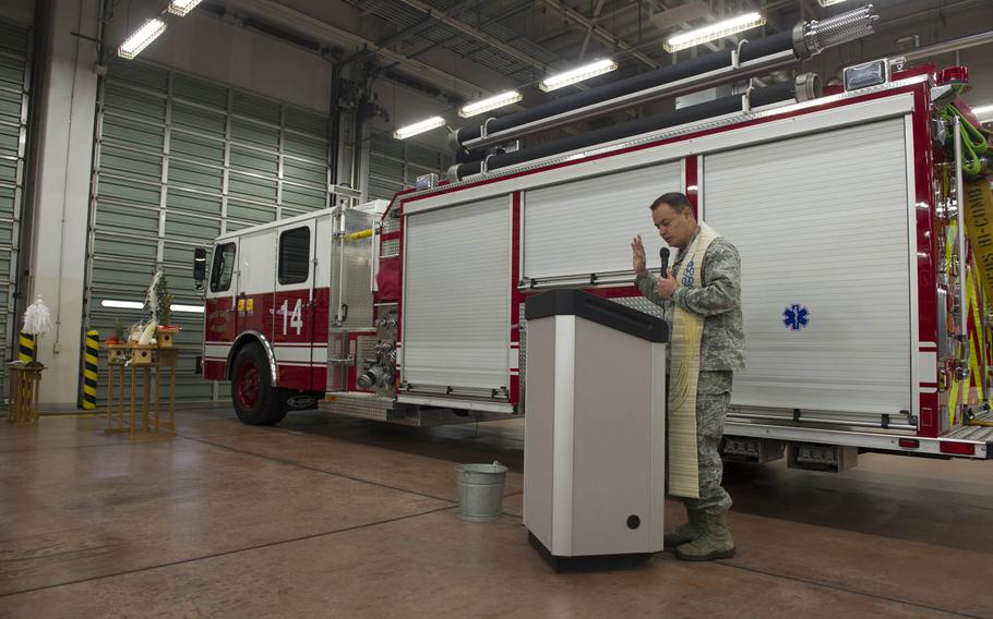 Maj. Oscar Fonseca, 374th Airlift Wing chaplain, offers prayers during a ceremony for a new fire engine at Yokota Air Base, Japan, Nov. 25, 2015. Fonseca spoke about the importance of being spiritually protected as it can enable firefighters to carry out their job more effectively.