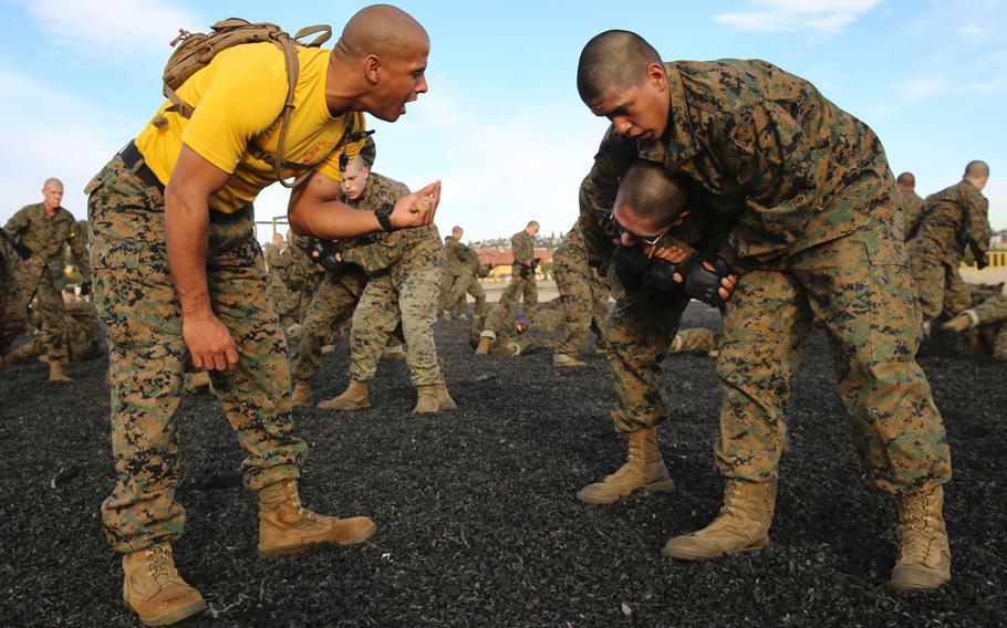 A drill instructor of Company F, 2nd Recruit Training Battalion, advises a recruit on how to execute a counter-choke during a Marine Corps Martial Arts Program session at Marine Corps Recruit Depot San Diego, Nov. 30, 2015.