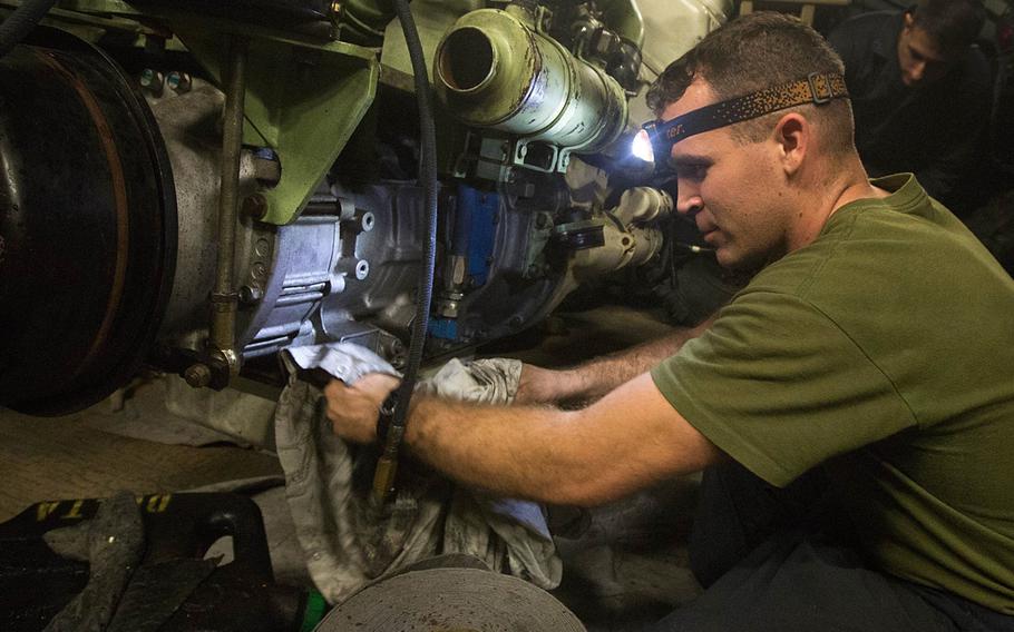 Sgt. Kevin S. Kuykendall, a light armored vehicle crewman with Light Armored Reconnaissance Company, Battalion Landing Team 2nd Battalion, 6th Marines, 26th Marine Expeditionary Unit, cleans an LAV engine aboard the amphibious assault ship USS Kearsarge Dec. 4, 2015.