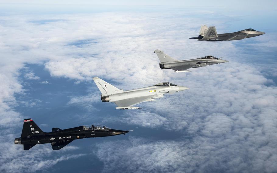 A U.S. Air Force T-38 Talon, British Royal Air Force Typhoon, French air force Rafale and U.S. Air Force F-22 Raptor fly in formation as part of a trilateral exercise held at Langley Air Force Base, Va., on Monday, Dec. 7, 2015.