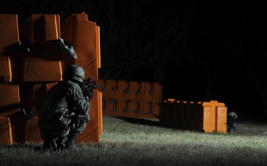 A member of the 22nd Security Forces Squadron takes cover while participating in proficiency firing training on Friday, Dec. 4, 2015, at McConnell Air Force Base, Kan.