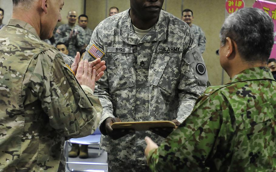 Staff Sgt. Brian Byrd, team lead chef, I Corps, accepts the 1st place plaque during the award ceremony for the Yama Sakura 69 Iron Chef Competition against a team from the Japan Ground Self-Defense Force at Camp Itami, Japan, Dec. 5, 2015. Yama Sakura is an annual, bilateral exercise with the Japan Ground Self-Defense Force and the U.S. military.