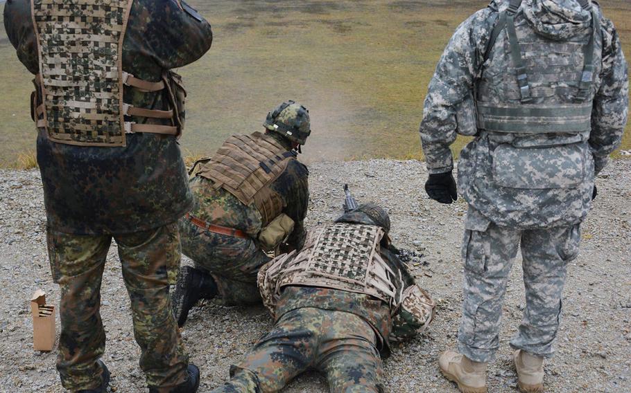 U.S. soldiers, assigned to the Combined Arms Training Center, 7th Army Joint Multinational Training Command, conduct a familiarization training with German soldiers on U.S. weapons at the JMTC???s Grafenwoehr Training Area, Germany, Dec. 9, 2015.