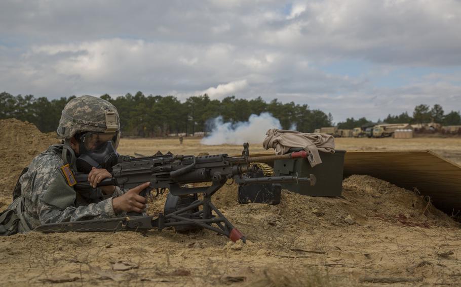 U.S. Army Pfc. Kirstin Lisenby, a Chinook mechanic assigned to the 122nd Aviation Support Battalion, 82nd Airborne Division, Fort Bragg N.C., participates in a field training exercise on a forward operation base where CS gas has been released at Fort Bragg, N.C., Dec. 9, 2015.