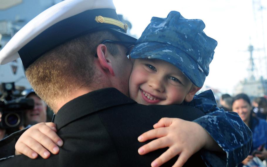 Ensign Carl Segerstrom hugs his son after his return to Norfolk from an eight-month deployment aboard the Arleigh Burke-class guided-missile destroyer USS McFaul on Dec. 14, 2015.