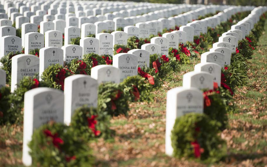 Wreaths were placed on headstones by volunteers during the Wreaths Across America event in Arlington National Cemetery, Dec. 12, 2015, in Arlington, Va.