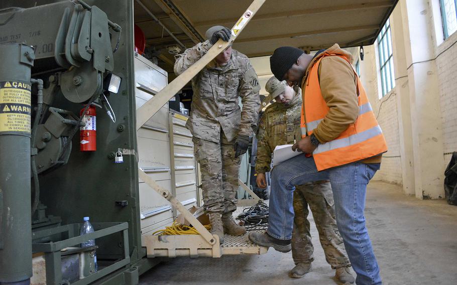Sgt. Glenn Prause and Sgt. Andrew Elias conduct inventories of a Forward Repair System with Clinton Kerney, a contractor from Kellogg, Brown and Root at Mumaiciai, Lithuania, Dec. 13, 2015, part of establishing a forward storage site by U.S. Army Europe and Army Materiel Command.