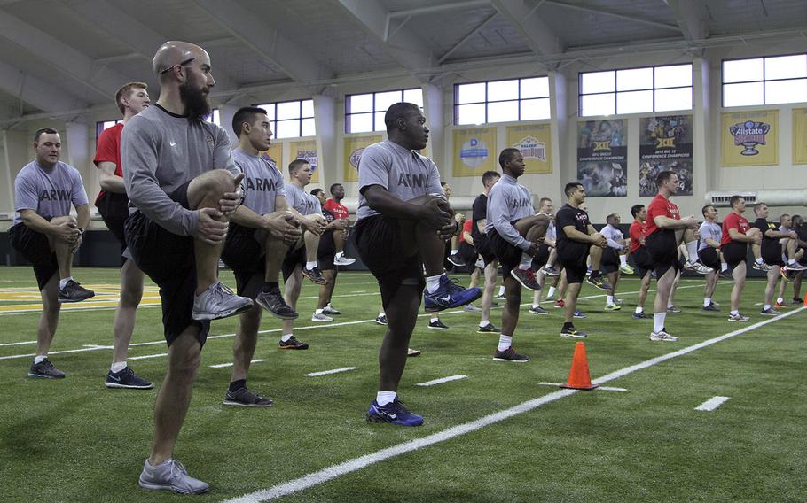 Baylor University athletic coaches lead Fort Hood soldiers through a combination of stretches and workouts Dec. 11, 2015, during a two-day physical training seminar with commanders and physical trainers from 91st Engineer Battalion, 1st Armored Brigade Combat Team, 1st Cavalry Division.