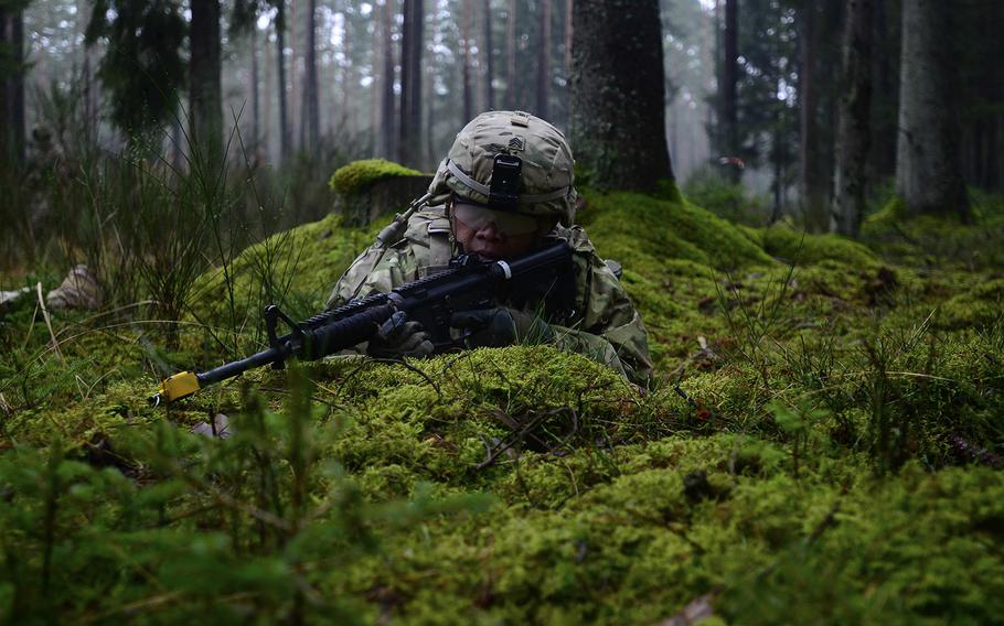 A soldier assigned to the 15th Engineer Battalion, 18th Military Police Brigade, moves tactically during a live-fire convoy exercise at the 7th Army Joint Multinational Training Command?s Grafenwoehr Training Area, Grafenwoehr, Germany, Dec. 15, 2015.