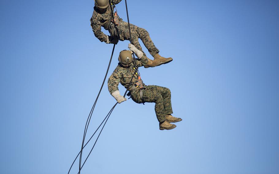 U.S. Marines assigned to 1st Battalion, 8th Marine Regiment and 2nd Recon Battalion rappel from a CH-53E Super Stallion during helicopter rope suspension training  near Marine Corps Air Station New River, N.C., Dec. 15, 2015.