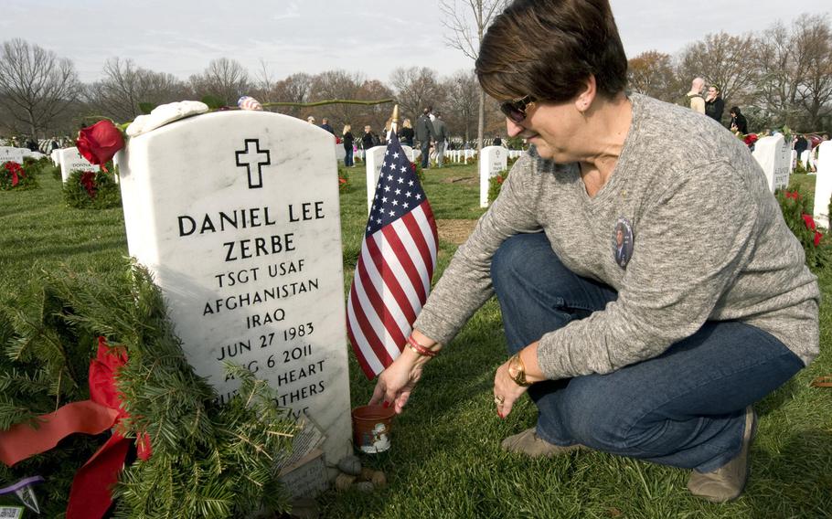Susan Zerbe prepares to place a wreath on the headstone for her son, Tech. Sgt. Daniel Lee Zerbe, who was one of 30 U.S. troops killed when a CH-47 Chinook helicopter was shot down in Afghanistan in 2011. Zerbe's mother and other family members of fallen troops were at the Arlington National Cemetery, Va., on Dec. 12, 2015, for Wreaths Across America Day, an event to honor veterans during the holidays.
