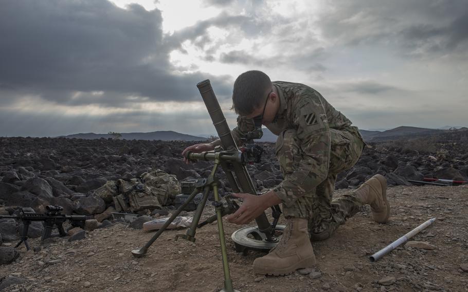 A U.S. Army indirect fire infantryman assigned to East African Response Force, Combined Joint Task Force-Horn of Africa, readies a mortar prior to a live-fire exercise in Djibouti, Dec. 16, 2015.