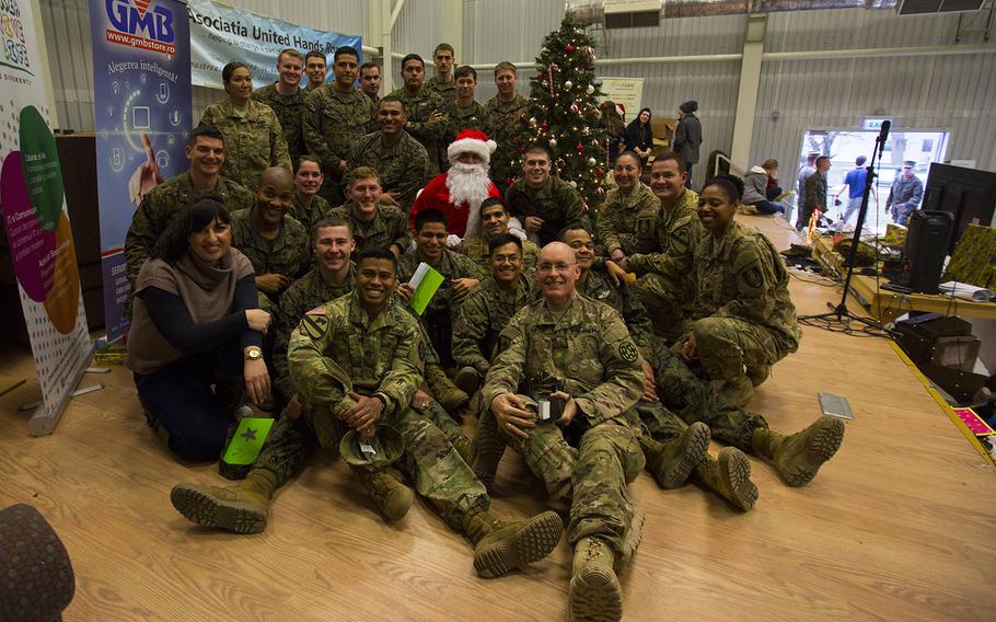 U.S. Marines, sailors, and soldiers celebrate an early Christmas at Mihail Kogalniceanu Air Base, Romania, Dec. 19, 2015.