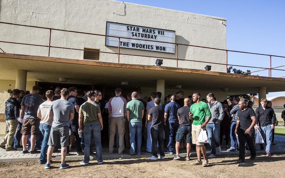 U.S. Marines, sailors and airmen gather at the Moron Air Base movie theater for a special premier of the latest Star Wars movie, Dec. 19, 2015.