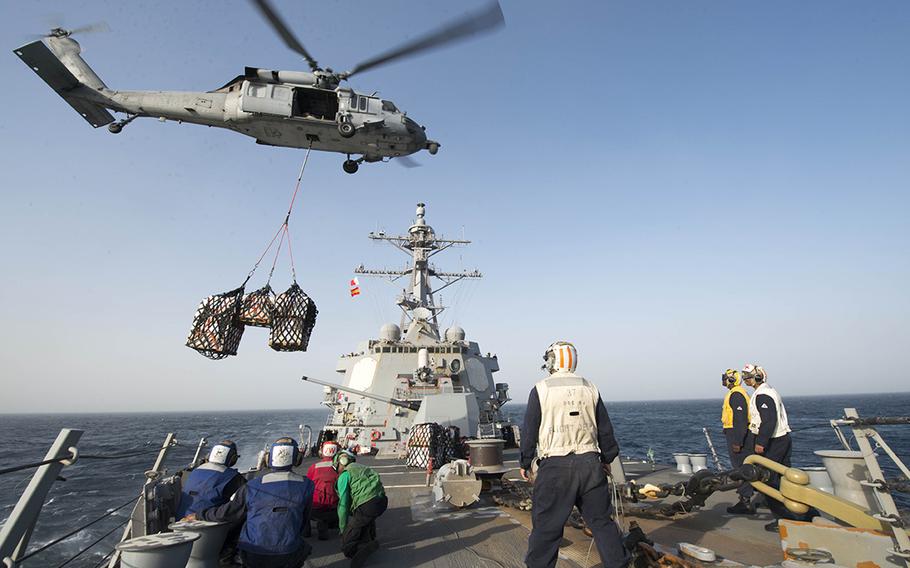 An MH-60S Sea Hawk helicopter lowers cargo onto the forecastle of guided-missile destroyer USS Bulkeley during a vertical replenishment Dec. 23, 2015.