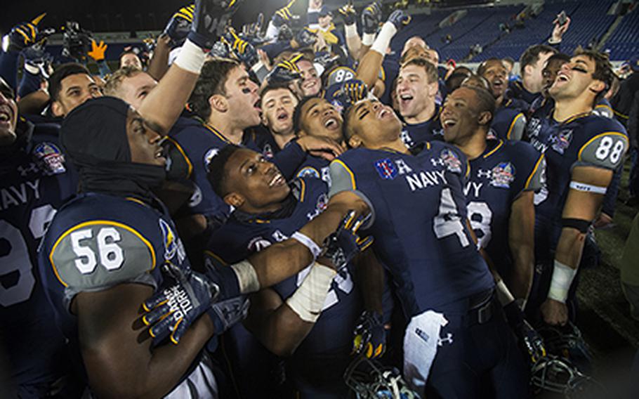 Navy celebrates a 44-28 victory over Pittsburgh in the 2015 Military Bowl at Navy-Marine Corps Stadium in Annapolis, Md., Dec. 28, 2015.