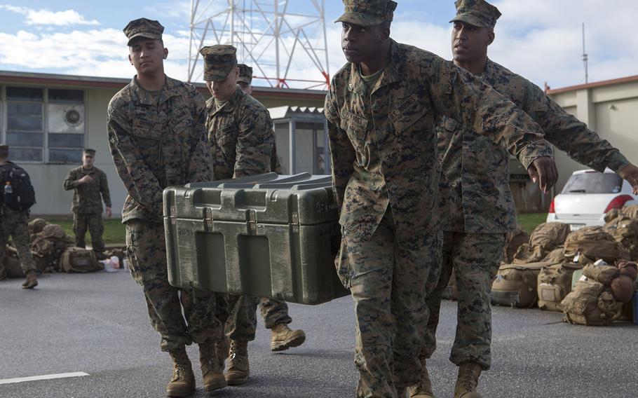 U.S. Marines with the 31st Marine Expeditionary Unit carry equipment to 7-ton trucks on Camp Hansen, Okinawa, Japan, Jan. 5, 2016.