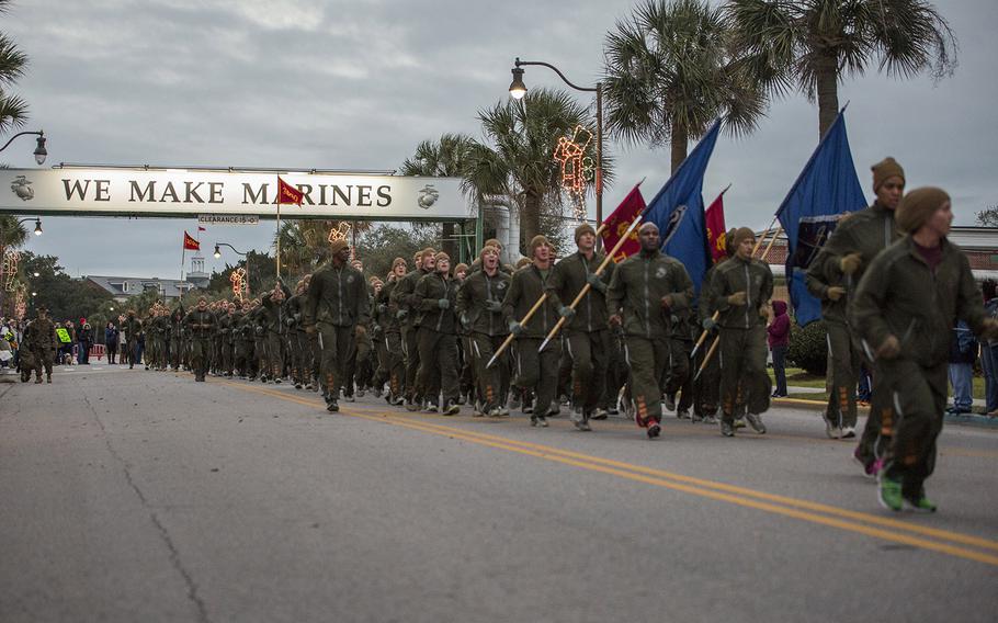 New U.S. Marines from Company I., 3rd Recruit Training Battalion, run under the ?We Make Marines? sign during a motivational run through the streets of Parris Island, S.C., on Jan. 7, 2016.