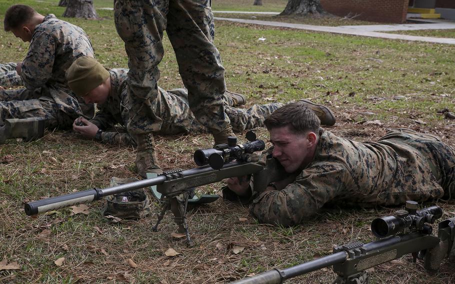 A U.S. Marine student undergoing the 2nd Marine Division Combat Skills Center Pre-Scout Sniper Course looks through an M40A5 sniper rifle at Camp Lejeune, N.C., Jan. 6, 2016.