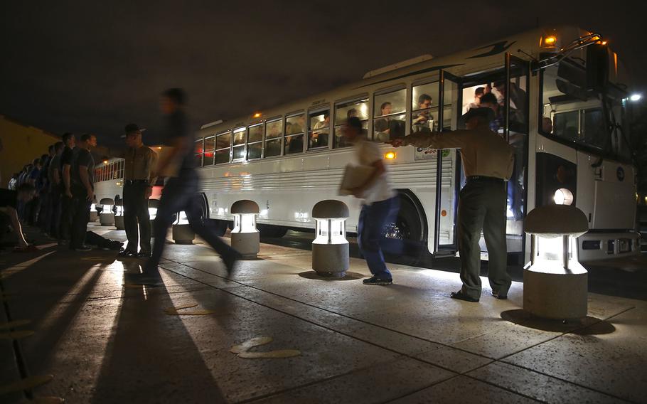 U.S. Marine Corps drill instructors with Receiving Company, Support Battalion, welcome new recruits to the depot as they get off the bus and step onto the yellow footprints during receiving at Marine Corps Recruit Depot San Diego, Calif., Jan. 19, 2016.