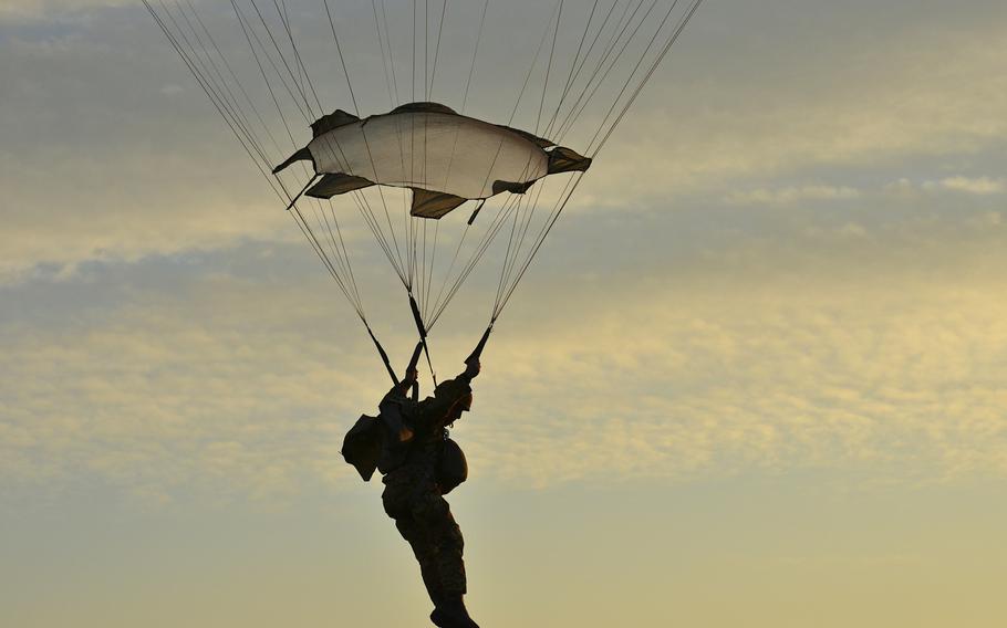 A U.S. Army paratrooper assigned to the 173rd Airborne Brigade prepares to land onto Juliet Drop Zone in Pordenone, Italy, Jan. 20, 2016, during an airborne operation from a U.S. Air Force 86th Air Wing C-130 Hercules aircraft.