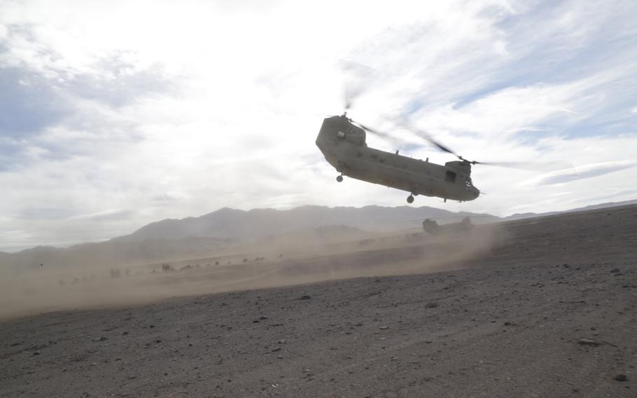 A CH-47 Chinook helicopter assigned to 2nd Stryker Brigade Combat Team, 2nd Infantry Division takes off at the National Training Center, Fort Irwin, Calif., Jan. 18, 2016.