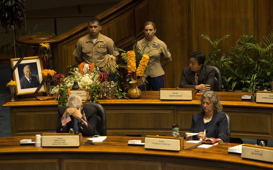 Sgt. Sergio Guerrero, left, and Staff Sgt. Cydney Rose, both with U.S. Marine Corps Forces, Pacific, watch over the seat of the late State Senator Gilbert Kahele, during a memorial ceremony at the Hawaii State Capitol building. Gilbert served as a U.S. Marine from 1960 to 1964.