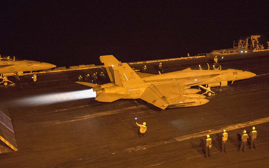 An F/A-18F Super Hornet, assigned to the ''Jolly Rogers'' of Strike Fighter Squadron 103, prepares to launch from the flight deck of aircraft carrier USS Harry S. Truman Jan. 24, 2016.