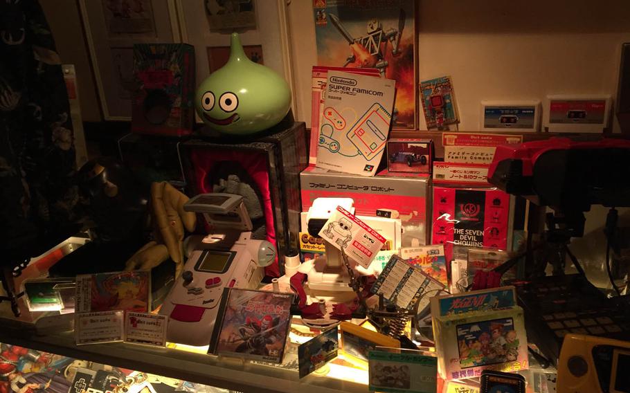 Kitschy knickknacks and relics of video games from past eras fill nearly available space at 8 Bit Cafe in Tokyo. You'll find Famicom, Super Famicom, tabletop and handheld game systems, character figurines, a giant working Nintendo Game Boy and a seemingly endless supply of comics, game-strategy guides and vintage instruction booklets.