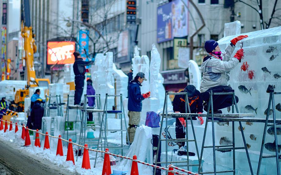 Sculptors work on their projects in Sapporo, Japn's Minami-cho in preparation of the Sapporo Snow Festival  Feb. 3, 2016. The Sapporo Snow Festival is scheduled to start Friday, Feb. 5 with the final displays being taken down by February 18.