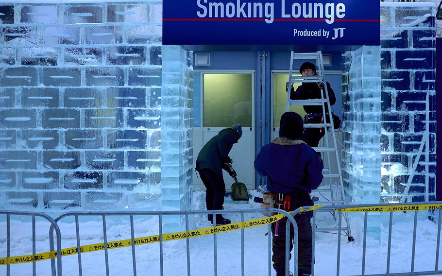 Workers put the finishing touches on a smoking lounge in Sappor, Japan's Odori Park Feb. 3, 2016. The Sapporo Snow Festival is scheduled to start Friday, Feb. 5 with the final displays being taken down by February 18.