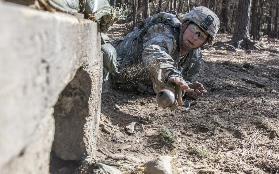 A soldier in Basic Combat Training with Company C, 1st Battalion, 61st Infantry Regiment, tosses a practice grenade into a bunker on the hand grenade assault course at Fort Jackson, S.C., Feb. 1, 2016.