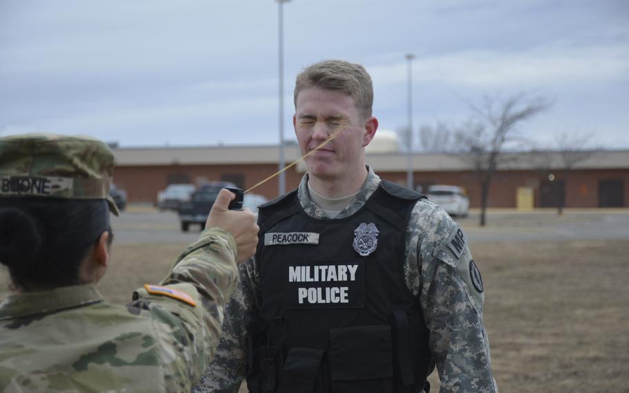 A soldier with the 97th Military Police Company shoots oleoresin capsicum, or pepper spray, into the face of a simulated assailant during a law enforcement competition on Fort Riley, Kan., Feb. 1, 2016.