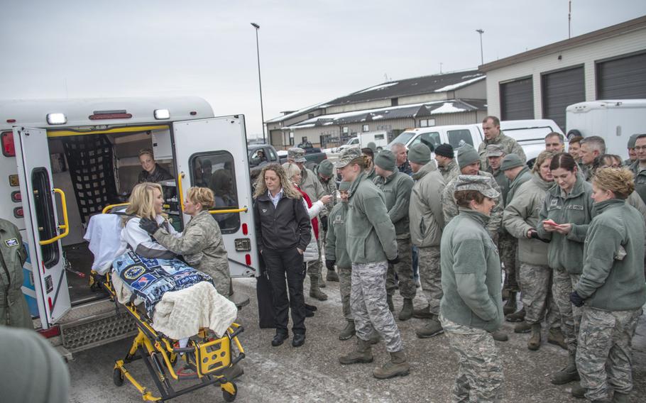 Wounded airman Staff Sgt. Taylor Savage is greeted by nearly 100 members of the 133rd Airlift Wing to see her off on her return flight to Scott Air Force Base, Ill., Jan. 27, 2016.  Savage and her mother needed assistance transporting her from the hotel to the aircraft upon leaving Minnesota because she has to be transported by litter. Members throughout the 133rd Airlift Wing teamed up to help pack her things, transport her and her belongings and get her on a flight back home.