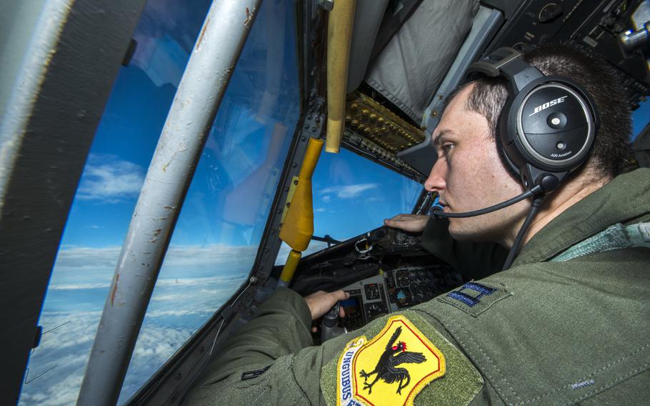 U.S. Air Force Capt. Christopher Thompson, 909th Air Refueling Squadron KC-135 Stratotanker pilot, scans the horizon for other aircraft during Forceful Tiger, Jan. 28, 2016, near Okinawa, Japan. The 909th ARS, which is charged with supplying fuel to other aircraft in flight, delivered a total of 1.3 million pounds of fuel to more than 130 aircraft during the large force exercise.