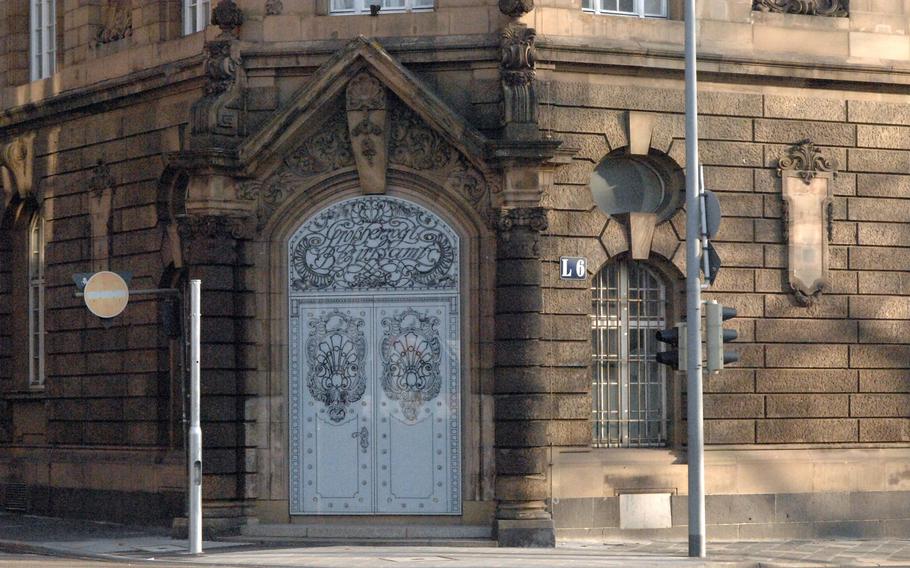An ornate door stands at the corner of block L6 in Mannheim, Germany. Mannheim's city center is arranged in an orderly grid of streets identified by numbers and letters.
