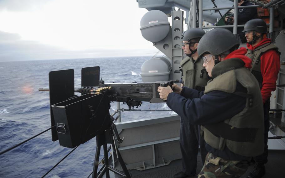 Airman Dylan Williams, an aviation ordnanceman, fires a .50 caliber machine gun as Petty Officer 2nd Class Levi Horn, a gunner's mate, and Airman Donald Woods, an aviation ordnanceman, look on during a live fire exercise aboard amphibious assault ship USS Boxer on Feb. 15, 2016. More than 4,500 sailors and Marines from Boxer Amphibious Ready Group and embarked 13th Marine Expeditionary Unit are transiting the Pacific Ocean en route to the U.S. 5th and 7th Fleet areas of operations.