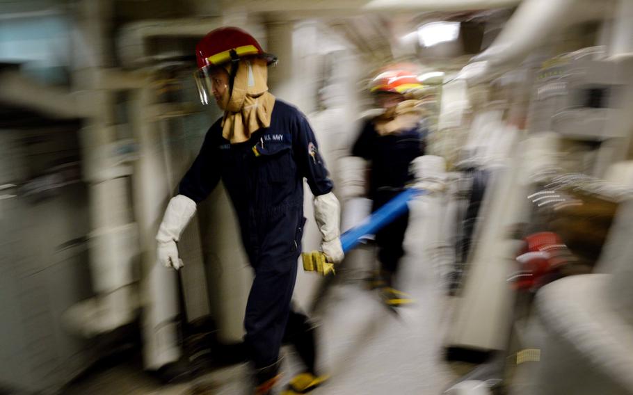 Sailors aboard USS Ross conduct simulated damage control training in the Mediterranean Sea on Feb. 15, 2016.