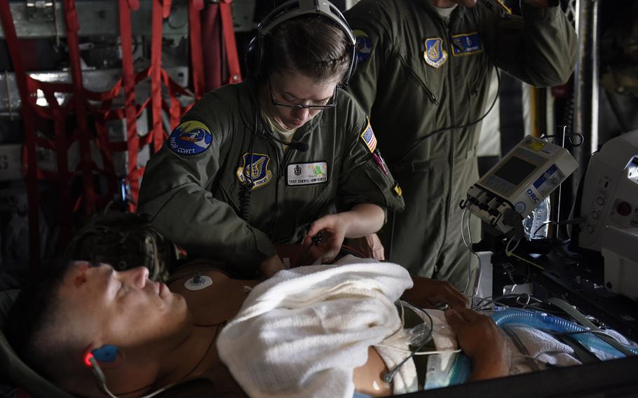 U.S. Air Force Tech. Sgt. Cheryl-Ann Kuntz, a respiratory therapist assigned to the 15th Medical Group at Joint Base Pearl Harbor-Hickam, provides medical care for U.S. Coast Guard Petty Officer 1st Class Michael Hall for a simulated head wound during an Aeromedical Evacuation flight to Andersen Air Force Base, Guam, Feb. 15, 2016, as part of the Humanitarian Assistance and Disaster Relief training exercise Cope North 2016.