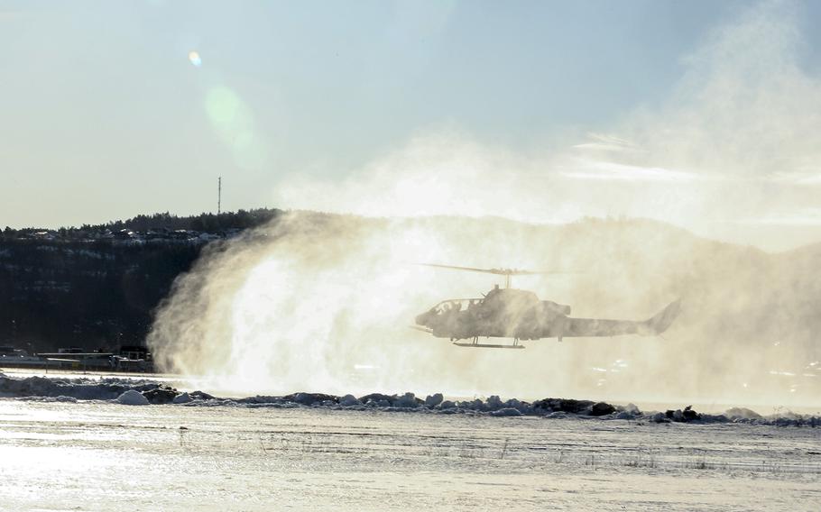 A U.S. Marine Corps AH-1W Super Cobra helicopter kicks up snow at Vaernes, Norway, Feb. 22, 2016, as 2nd Marine Expeditionary Brigade prepares for Exercise Cold Response.