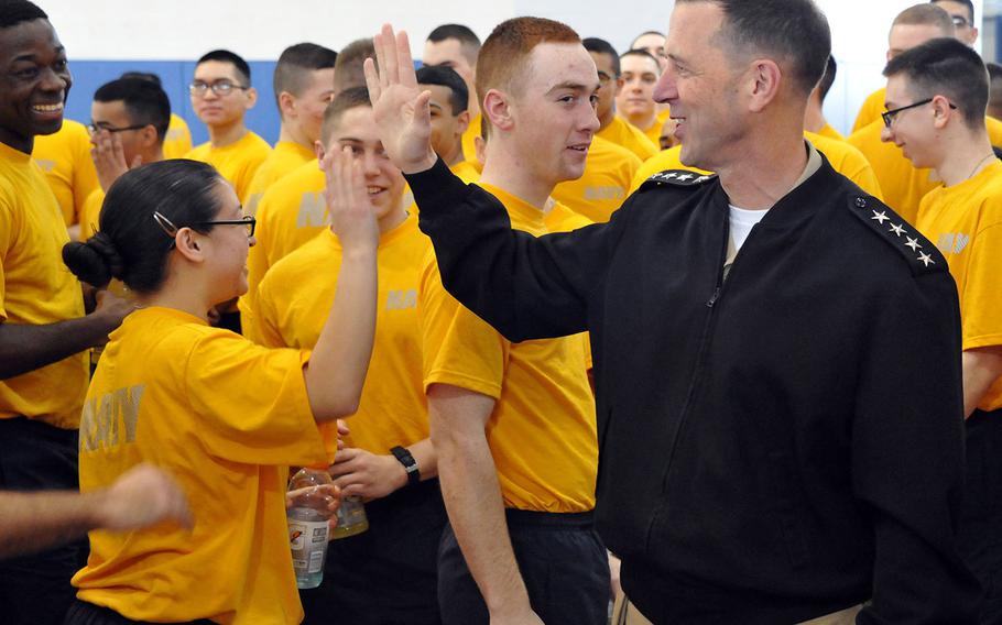 Chief of Naval Operations Adm. John Richardson ''high-fives'' recruits during a weekly Recruit Training Command Captain's Cup between soon-to-be-graduating recruit divisions in Great Lakes, Ill., on Feb. 27, 2016.