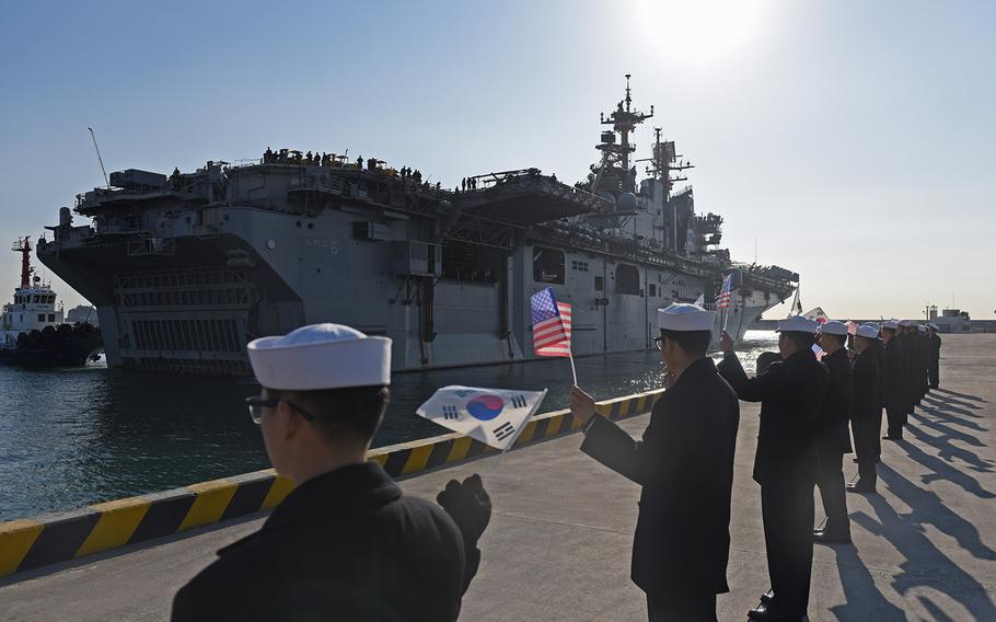 Republic of Korea sailors wave U.S. and South Korean as USS Bonhomme Richard pulls into ROK Fleet base in Busan on March 3, 2016.
