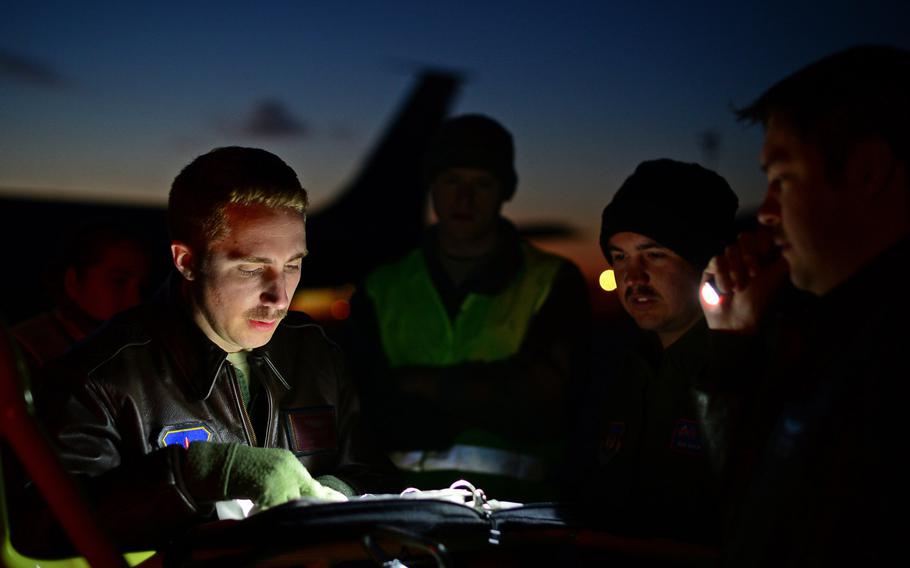 U.S. Air Force servicemembers assigned to RAF Mildenhall, England, review flight plans on the flight line at Istres-Le Tub? Air Base, France, Feb. 26, 2016. Since 2013, the U.S has been supporting the French government in Operation Juniper Micron by providing air refueling and airlift support to French operations in Mali and North Africa.