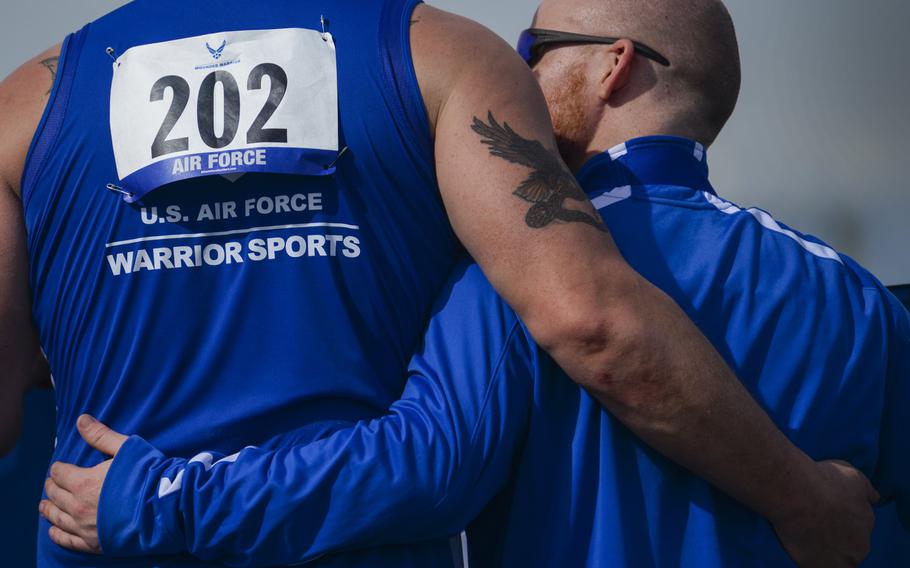 Air Force Trials competitors embrace during a medal ceremony at the 2016 Air Force Wounded Warrior Trials track and field competition at Nellis Air Force Base, Nev., March 1, 2016. The Air Force Trials are an adaptive sports event designed to promote the mental and physical well-being of seriously wounded, ill and injured military members and veterans.