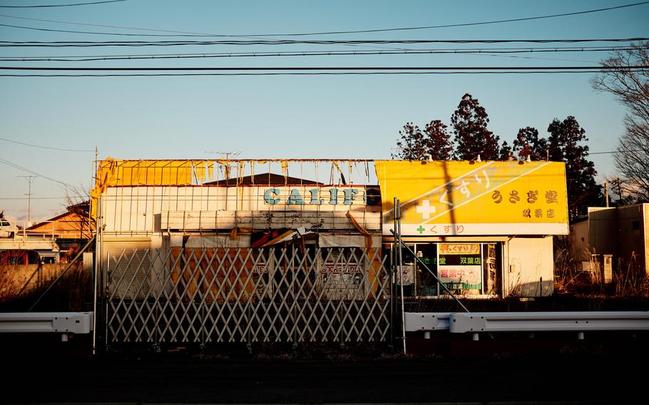 Much of the sign on an abandoned drug store has fallen, revealing part of the previous tenant's name in Futaba, Japan, near the severely damaged Fukushim Daiichi nuclear power plant, Feb 10, 2016.