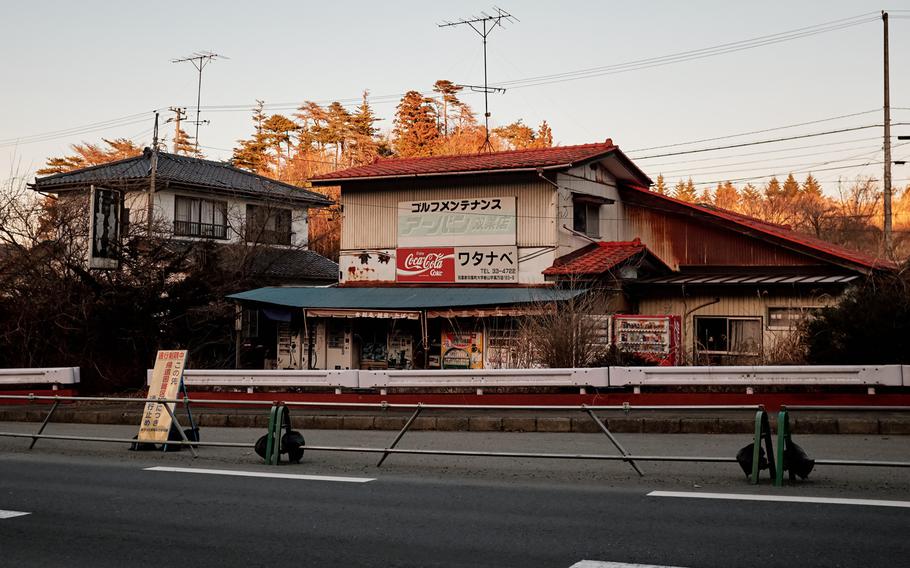 An independent convenience store sits abandoned next to a homemade goods shop behind the exclusion zone in the ghost town of Futaba, Japan, Feb. 10, 2016. The vending machines outside still have stock inside, though power hasn't been restored to the area.