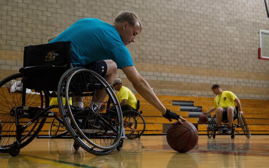 A U.S. Marine with the Wounded Warrior Regiment practices his dribbling during an orientation to wheelchair basketball as part of the 6th annual Marine Corps Trials at Marine Corps Base Camp Pendleton, Calif., March 4, 2016. The Trials, an eight-event adaptive sports competition, is hosted by the Wounded Warrior Regiment.