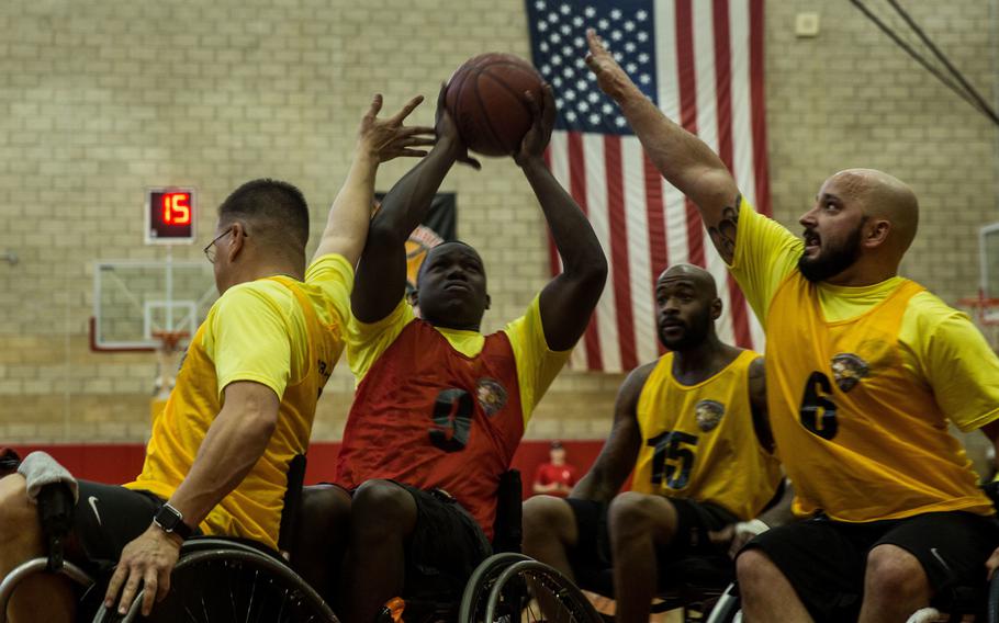 U.S. Marine Corps Cpl. Leon Simpson, a Port Charlotte, Fla., native with Wounded Warrior Battalion?East, attempts to shoot the ball at the wheelchair basketball competition during the 2016 Marine Corp Trials aboard Marine Corps Base Camp Pendleton, Calif., on March 9, 2016.