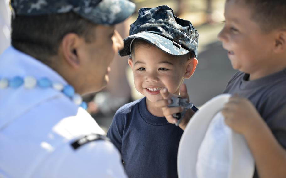 Petty Officer Claro Marasigan, a culinary specialist, greets his sons, Cameron, right, and C.J., on March 17, 2016, following the return of the USS North Carolina to Joint Base Pearl Harbor, Hawaii, after completing a six-month Western Pacific deployment.